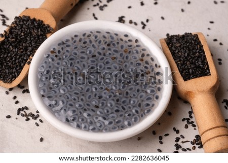 basil seeds in a wooden spoon and a cup of basil water. selasih. ocimum. Royalty-Free Stock Photo #2282636045