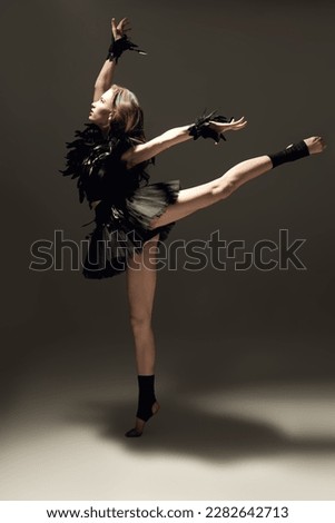 Beautiful modern ballet dancer girl. Dance expression. Contemporary ballet. Full-length studio portrait.