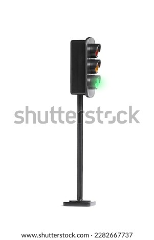 Side shot of a traffic light with flashing green light isolated on white background