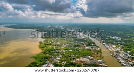 Aerial view landscape of the Mekong Delta in Sa Dec, Dong Thap, Vietnam, residential development, waterway transport, and agricultural economy in Vietnam