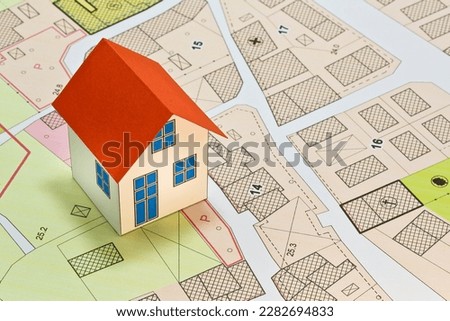 New home and free vacant land for building activity - Construction industry and building permit concept with a residential area, cadastral map, General Urban Planning and zoning regulations   Royalty-Free Stock Photo #2282694833