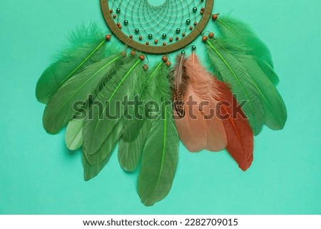 Beautiful dream catcher on turquoise background