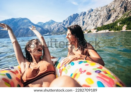 Friends having fun on their summer vacation.Group of friends swimming and having fun at the sea.