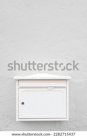View of mailbox on white building wall Royalty-Free Stock Photo #2282715437