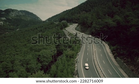 Aerial shot of a modern highway traffic in the mountains