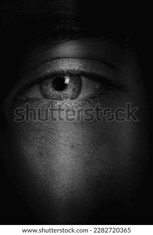 close-up of an eye  in the shadows Royalty-Free Stock Photo #2282720365