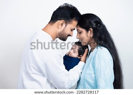 Portrait of Indian parents with newborn baby, Young asian couple holding little baby in hand. Beautiful family. Parenthood. Royalty-Free Stock Photo #2282728117