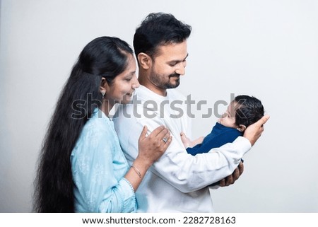 Portrait of Indian parents with newborn baby, Young asian couple holding little baby in hand. Beautiful family. Parenthood. Royalty-Free Stock Photo #2282728163