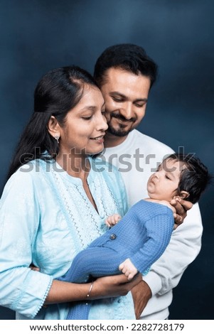 Portrait of Indian parents with newborn baby, Young asian couple holding little baby in hand. Beautiful family. Parenthood. Royalty-Free Stock Photo #2282728179