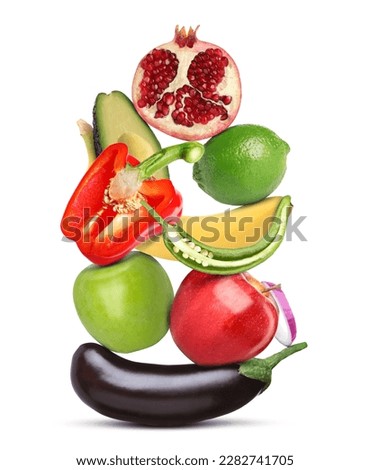Stack of different vegetables and fruits isolated on white