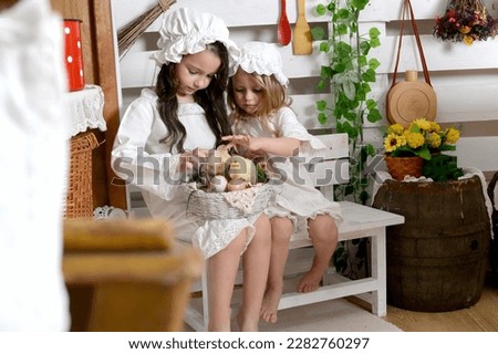 Two happy girls with yellow small chicks . Retro picture