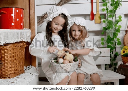 Two happy girls with yellow small chicks . Retro picture