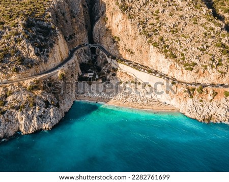 Aerial drone photograph capturing sunbathers enjoying the beautiful Kaputaş Beach in Kaş, Antalya, highlighting the vibrant atmosphere and stunning seaside landscape of this popular vacation spot. Royalty-Free Stock Photo #2282761699