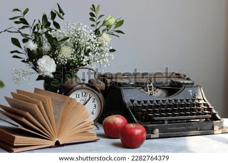 Open book on a table. Close up photo of yellow pages of an old book. Simple composition still life with white gypsophila flowers and book. 
