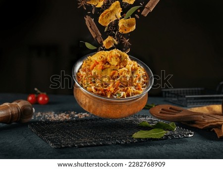 indian chicken biryani, Spicy chicken biryani food photography, flying food, black background. Royalty-Free Stock Photo #2282768909