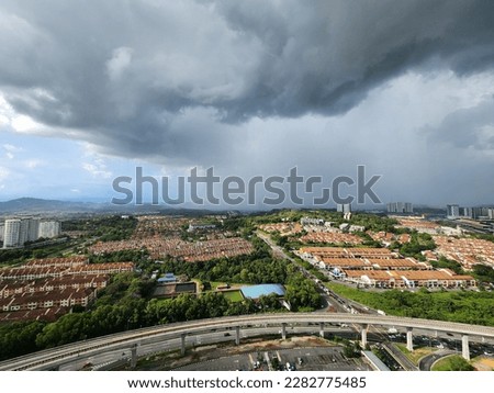 The calm before the storm: a breathtaking scene of a sunny foreground and storm clouds approaching from distance