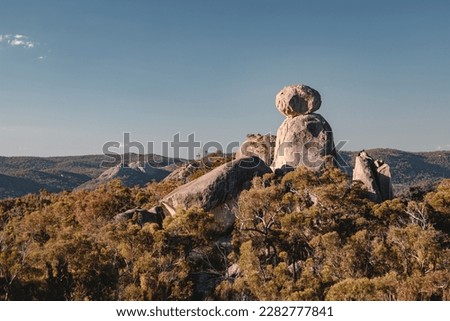 The sun begins to set over The Sphinx, one of many granite monoliths adorn the landscape of Girraween National Park, Australia. Royalty-Free Stock Photo #2282777841