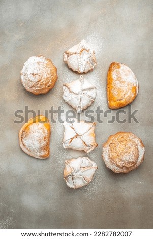muffins and cupcakes sprinkled with powdered sugar, vertical image. top view. place for text.