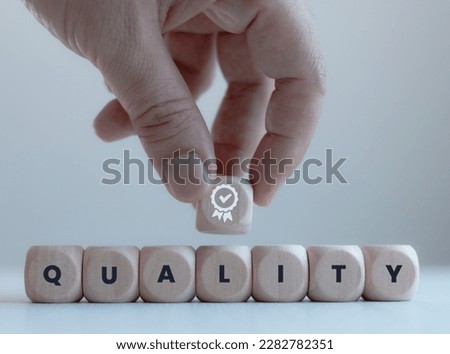 Wooden blocks text and icons, quality management concept with quality assurance or qa and quality control or qc and standards improvement certification concept.