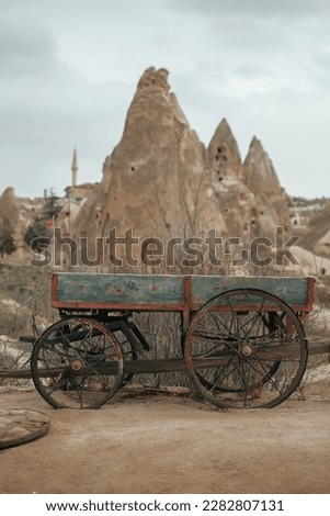 Old cart with unique rock formations in background, Cappadocia, Turkey 