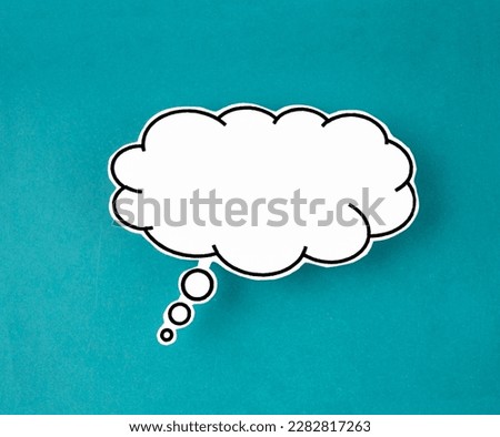 White speech bubble shaped post it note on green background with copy space. Royalty-Free Stock Photo #2282817263