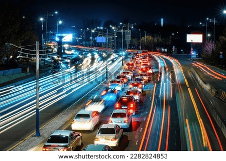 Car traffic light at night city highway. Royalty-Free Stock Photo #2282824853