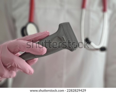 Ultrasound dopplerography and doppler in doctor cancers. Modern medical ultrasound transducer used in neurology for transcranial studies Royalty-Free Stock Photo #2282829429