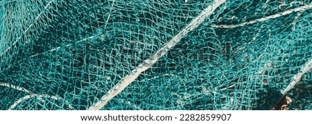 BANNER abstract close-up macro real photo beautiful wallpaper. Fisherman rope net texture fiber surface pattern. Sea blue green light colour. Futuristic subtle waving lines art modern. Dark background