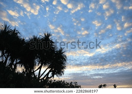 evening atmosphere on the beach when the sun sets with beautiful clouds