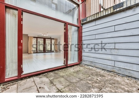an empty room in a house that has been painted red and is being used as a place to display art