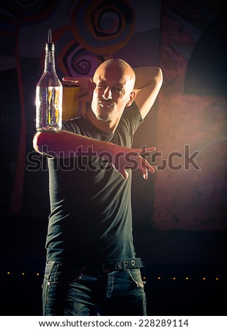 Acrobatic show barman performing exhibition move at night club - Concept of freestyle american bartending in action - Bartender at working in disco party Royalty-Free Stock Photo #228289114