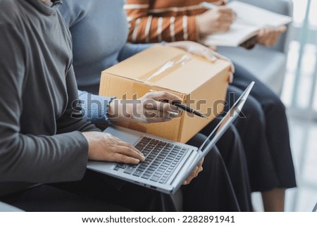 Close up group of independent asian female business sme online shopping working on laptop computer with parcel box on bed at home, SME online business and delivery concept.