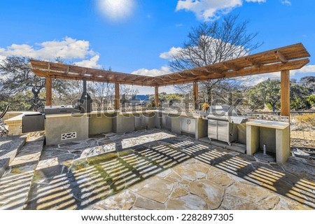 A back patio with a grill and outdoor kitchen 