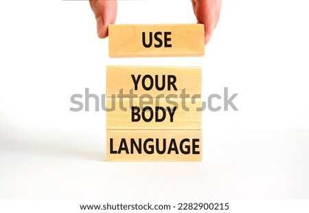 Use your body language symbol. Concept words Use your body language on wooden block. Beautiful white table white background. Motivational business Use your body language concept. Copy space.