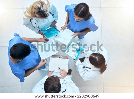 Doctor, team and documents in collaboration above in healthcare planning, meeting or brainstorming at hospital. Group of medical professionals with paperwork in teamwork, strategy or ideas at clinic Royalty-Free Stock Photo #2282908649