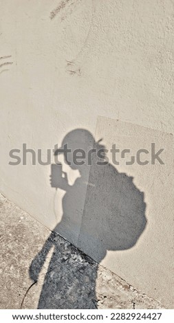 This is a girl's shadow picture carrying phone.