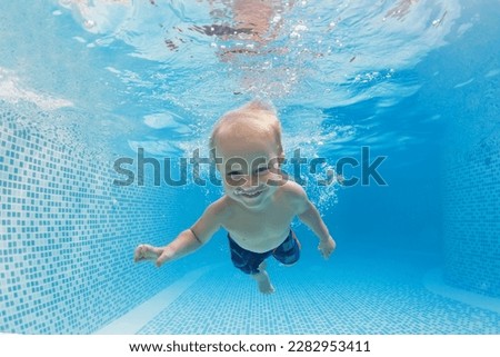Happy family have fun in swimming pool. Funny child swim, dive in pool - jump deep down underwater from poolside. Healthy lifestyle, people water sport activity, swimming lessons on holidays with kids
