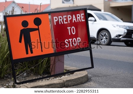 Red and orange metal with pictogram Sign ‘Prepare to Stop’ on a road in Tasmania to warn that part of the roadway is experiencing traffic congestion