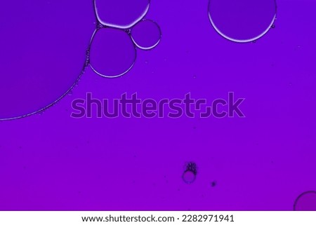 Macro close up of water bubbles with copy space over purple background. Macro, colour, water, shape and pattern concept.