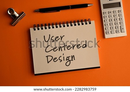 There is a notebook with the word User Centered Design. It is eye-catching image.