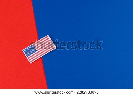 High angle view of flag of united states of america with copy space on blue and red background. American patriotism, independence day and tradition concept.