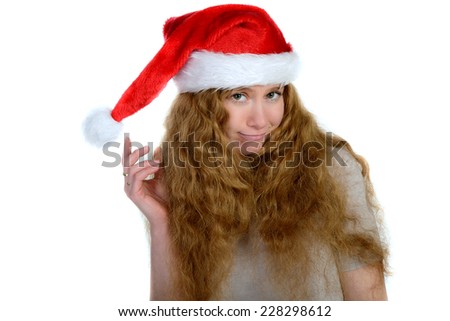attractive young woman with rad hair in santa hat