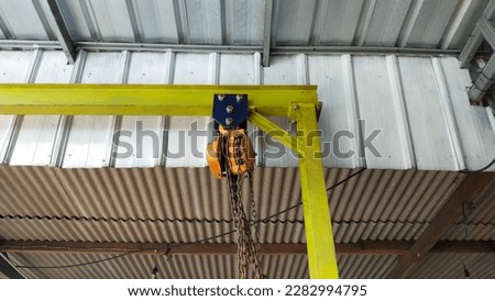 Pulley or in English snatch block or pulley block is a wheel on an axle or drive wheel designed to support the movement and change the direction of the cable or belt that is installed. Royalty-Free Stock Photo #2282994795