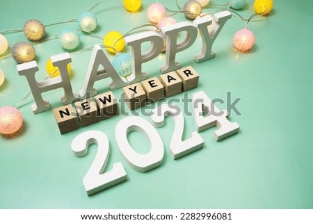 Happy New Year 2024 alphabet letter with LED cotton balls on green background