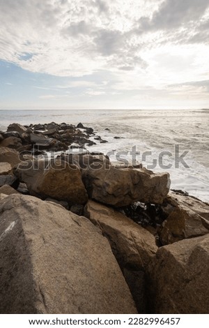 panoramic scene with clouds in the sky and rocks on the coast, tourist destination at day, landscape wallpaper with nature without people