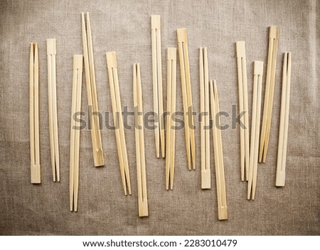 Many Asian wooden chopsticks  arranged in a row background. Lots of Chinese traditional eating utensils