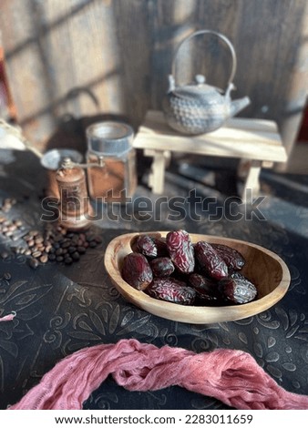 Dates dried fruit in a wooden bowl with blurry background resemble Ramadan for Muslim
