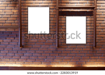 Blank poster frames on vintage wooden and brick wall. Poster mock up in retro interior room. 