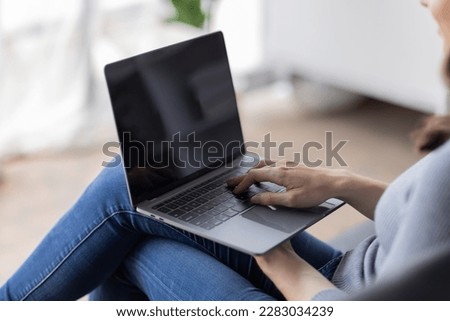 Portrait of  young happy canadian female freelancer checking email news online sitting on sofa,for friends, studying, blogging, resting and chatting online. High quality photo