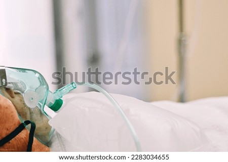 close up oxygen mask with reservoir bag, old asia woman patient in hospital, world health day, medical and healthcare wallpaper background, global pandemic crisis risk and problem concept